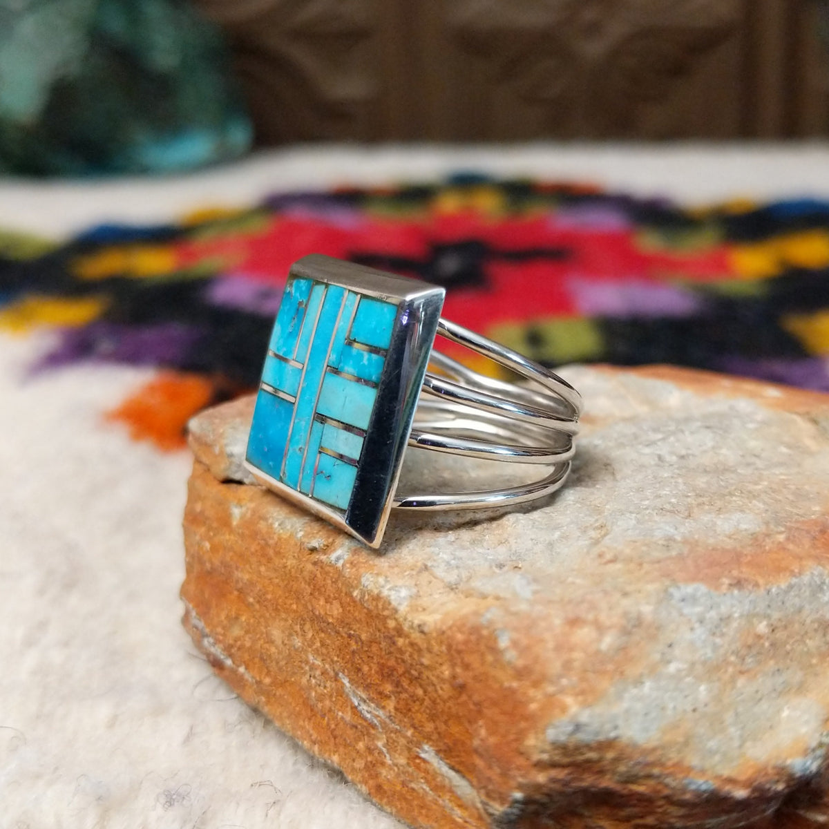 Navajo multistone mosaic shadowbox ring by A.Y. with geometric inlay and rectangular silver frame.