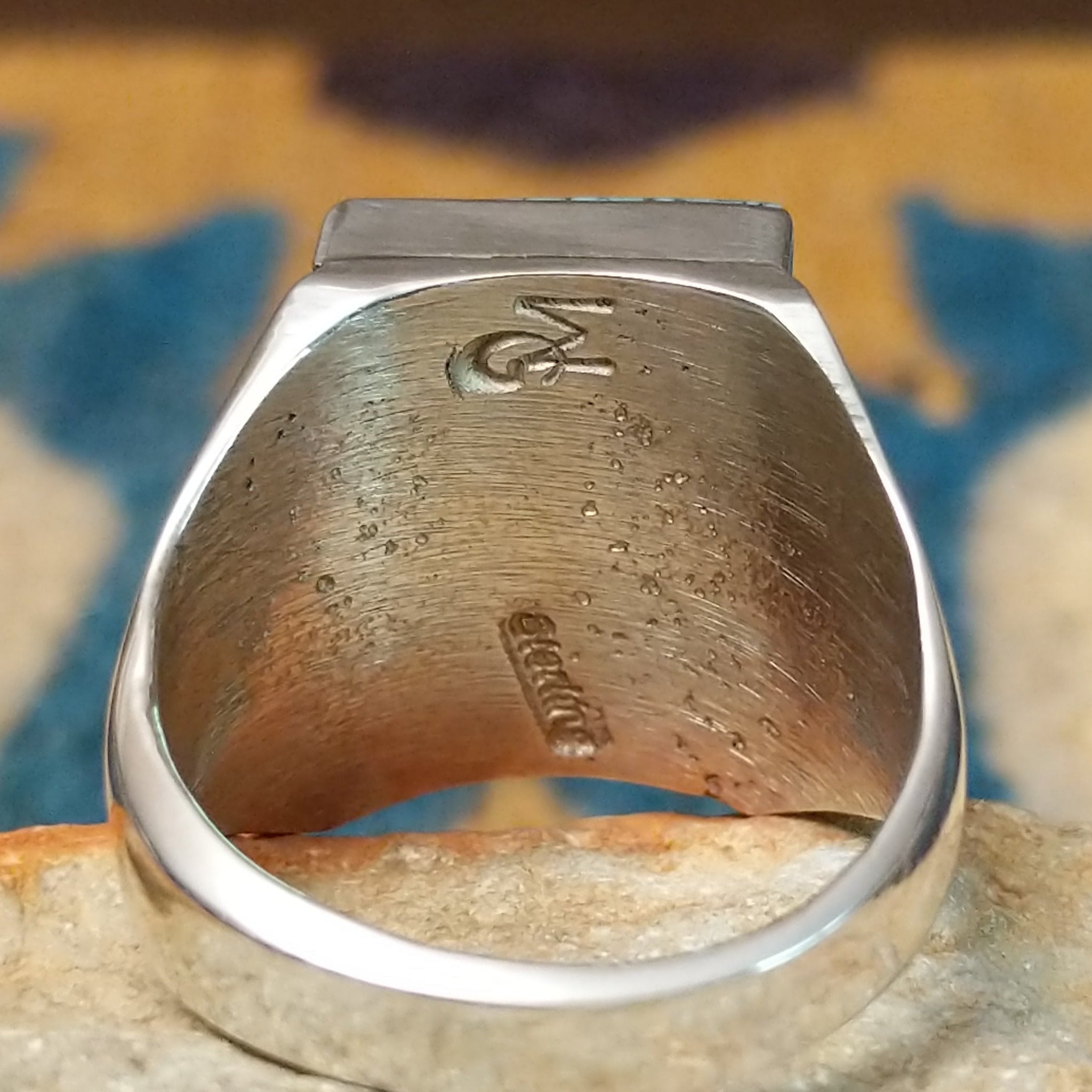 Handcrafted Navajo sterling silver ring by Wilbert Grey featuring a square turquoise mosaic inlay with natural black matrix, set in a polished bezel with a bold geometric design; artisan and Sterling Silver stamp.