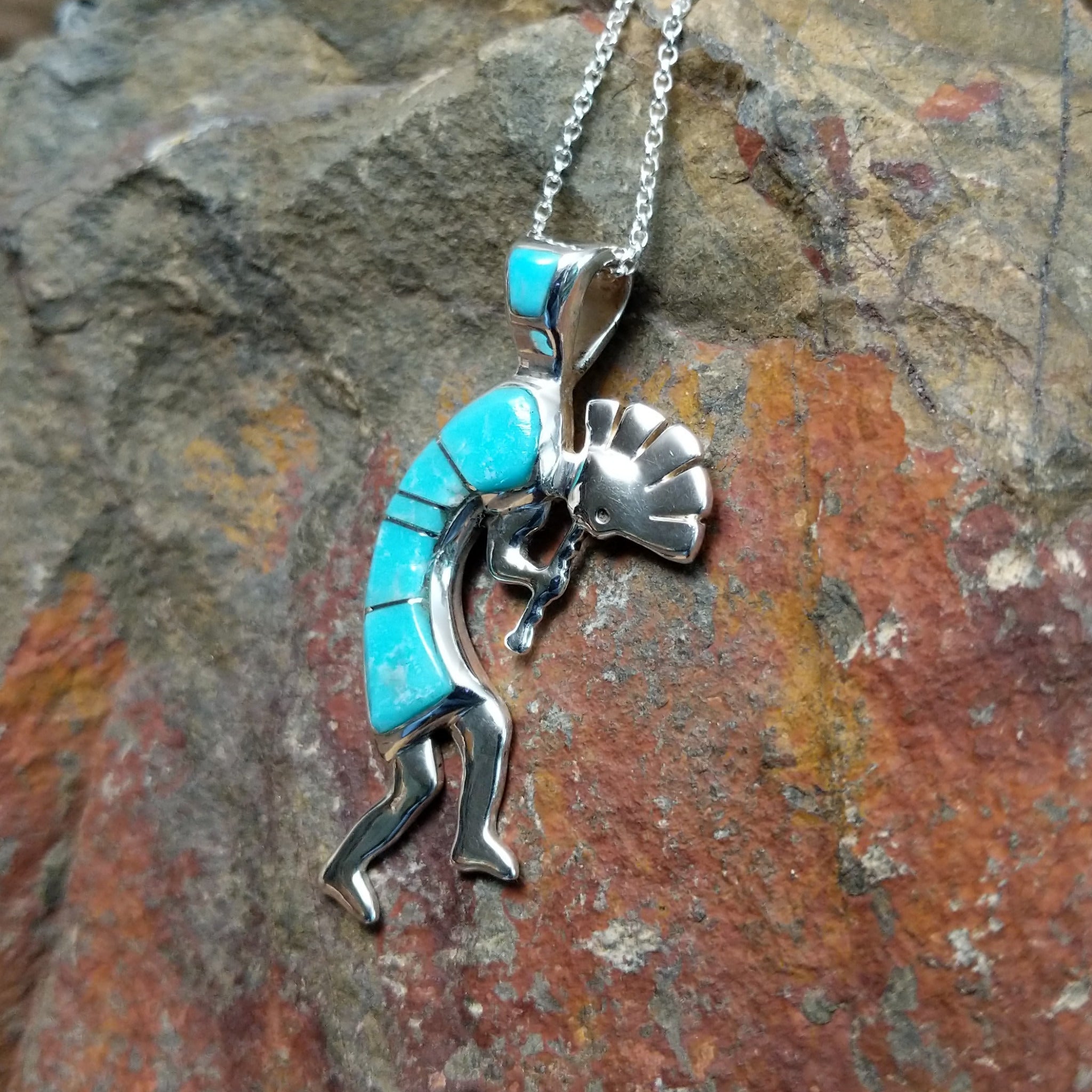 Handcrafted sterling silver turquoise Kokopelli pendant by Bernadine Joe, featuring a traditional Navajo Kokopelli design; side view.