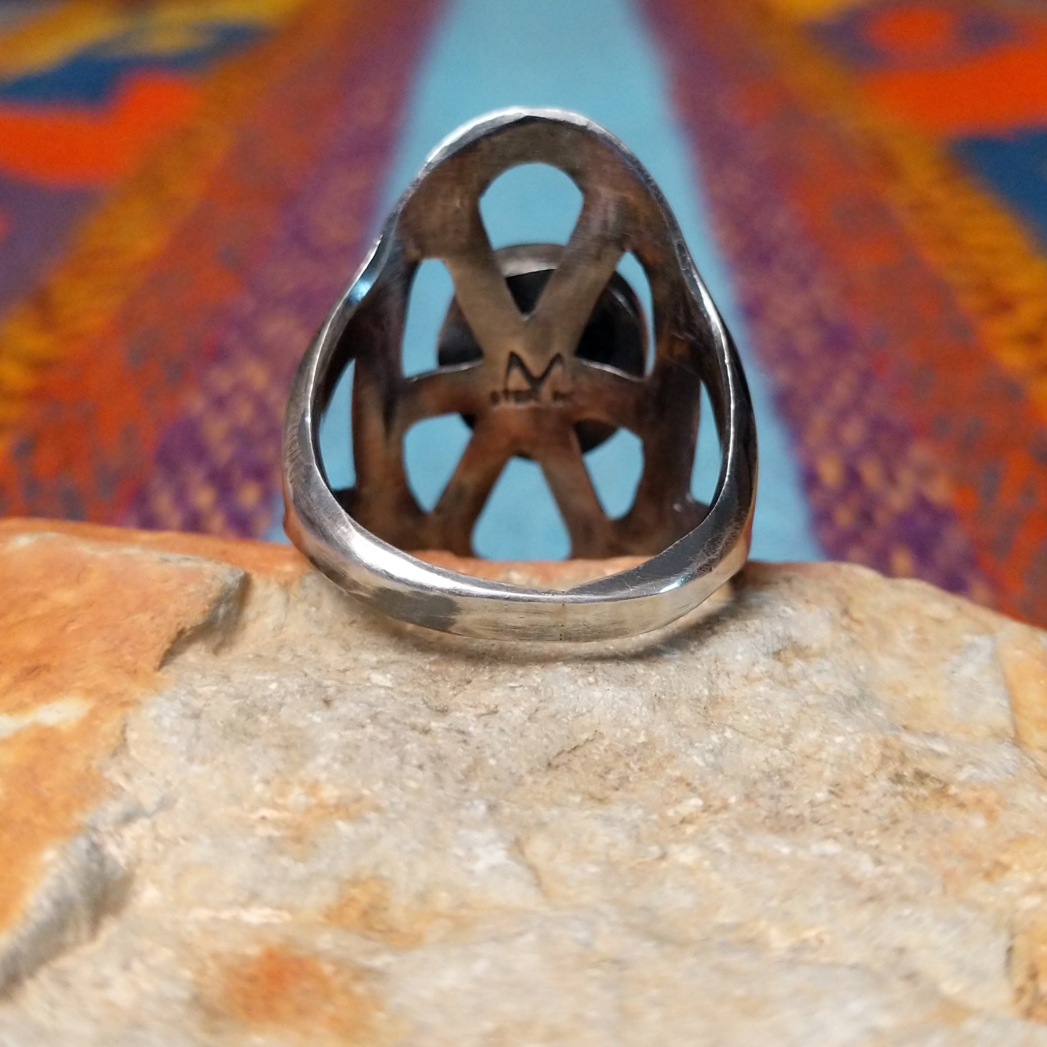 Turquoise Lattice Ring by Harry Morgan featuring an oval turquoise stone with natural matrix set in Sterling Silver, surrounded by bold sculpted lattice-style openwork; underside view.