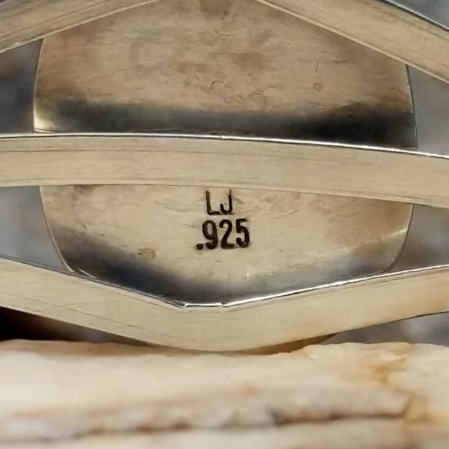 Close-up of the artisan's stamped initials.