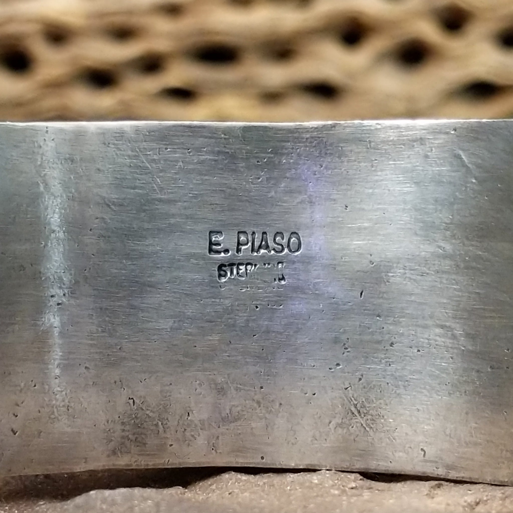 Turquoise Mountain turquoise cuff by E. Piaso, featuring a blue turquoise stone with a natural brown matrix set in a handcrafted wide sterling silver cuff; artisan and Sterling Silver stamp.