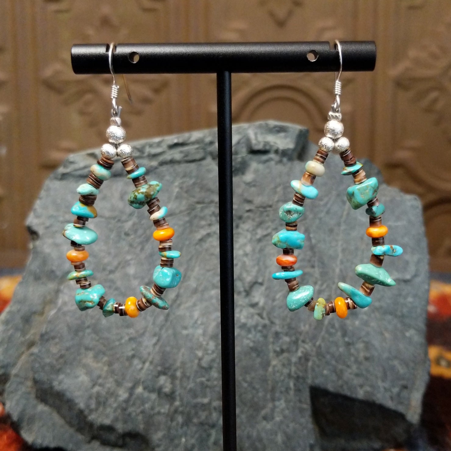 Matching dangle earrings display turquoise and orange spiny oyster shell heishi beads, suspended from sterling silver hooks.