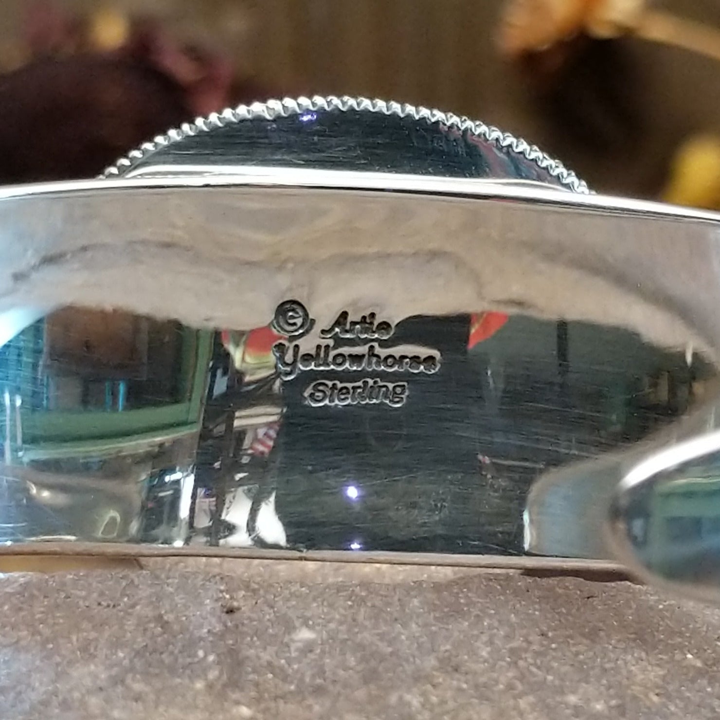 Close up of artist's stamped signature.