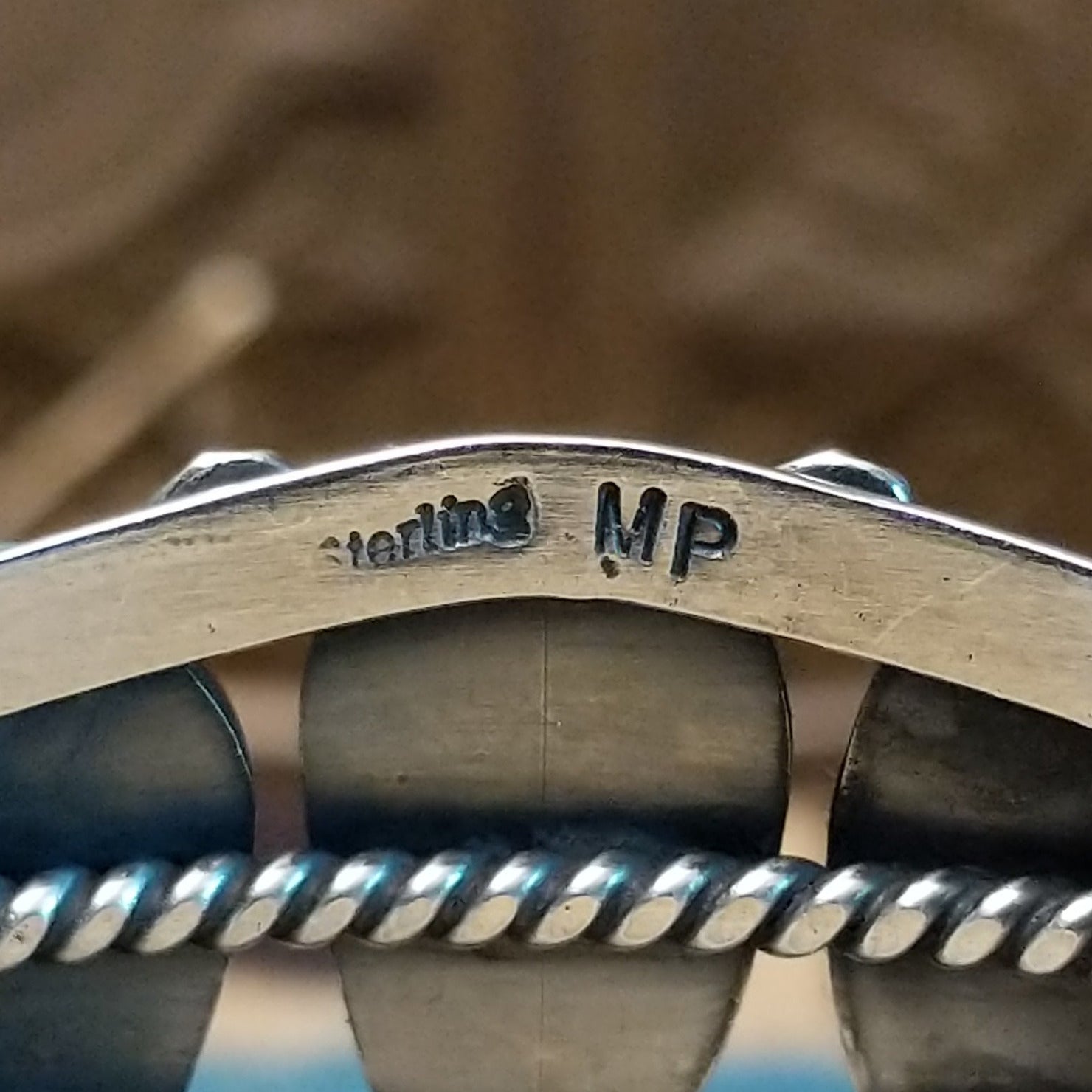 Close-up of the artisan's stamped signature.