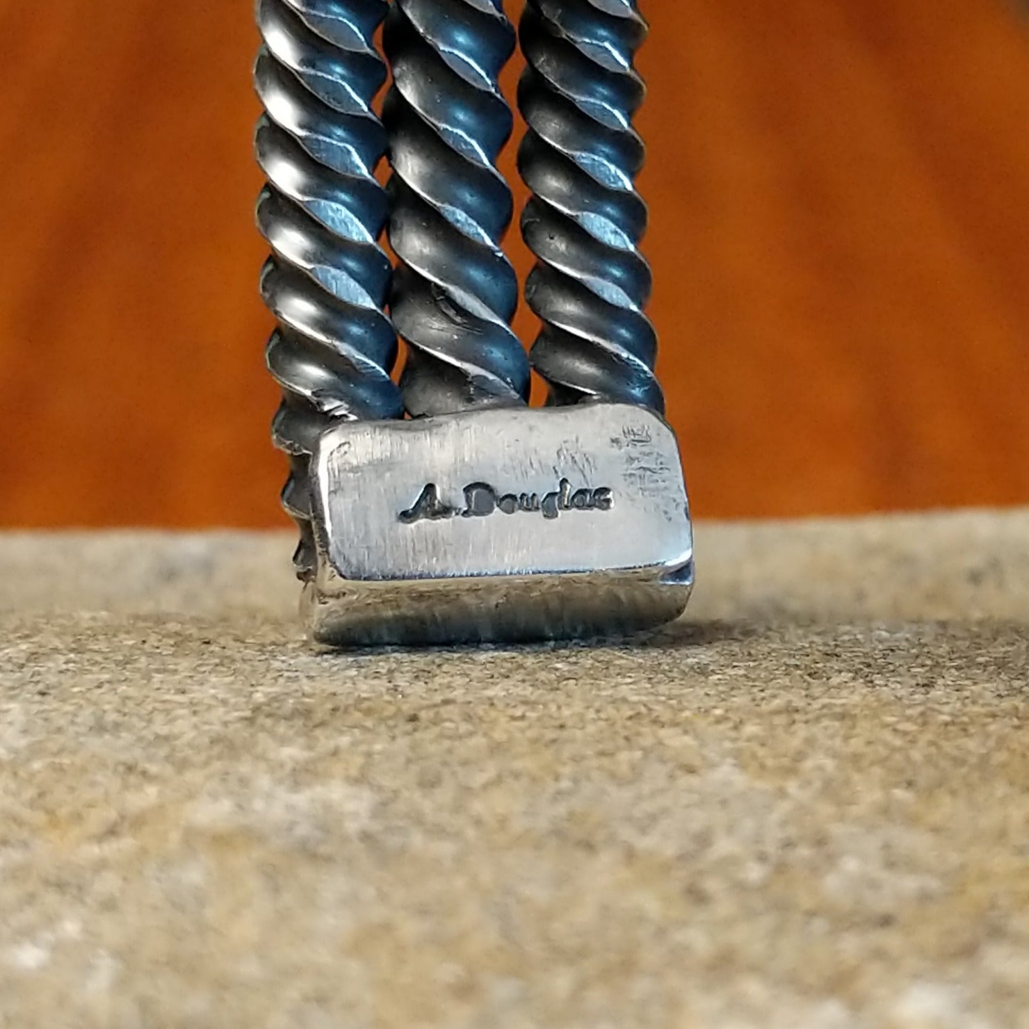 The tip of the cuff showcases the artisan's stamped signature.