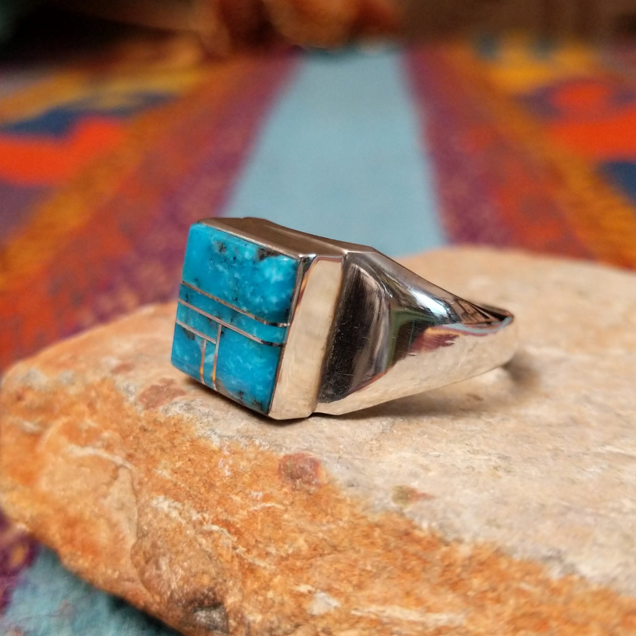 Turquoise Square Inlay Ring by Wilbert Grey featuring geometric turquoise inlay with natural matrix, separated by Sterling Silver channels and set on a polished tapered silver band; side view.