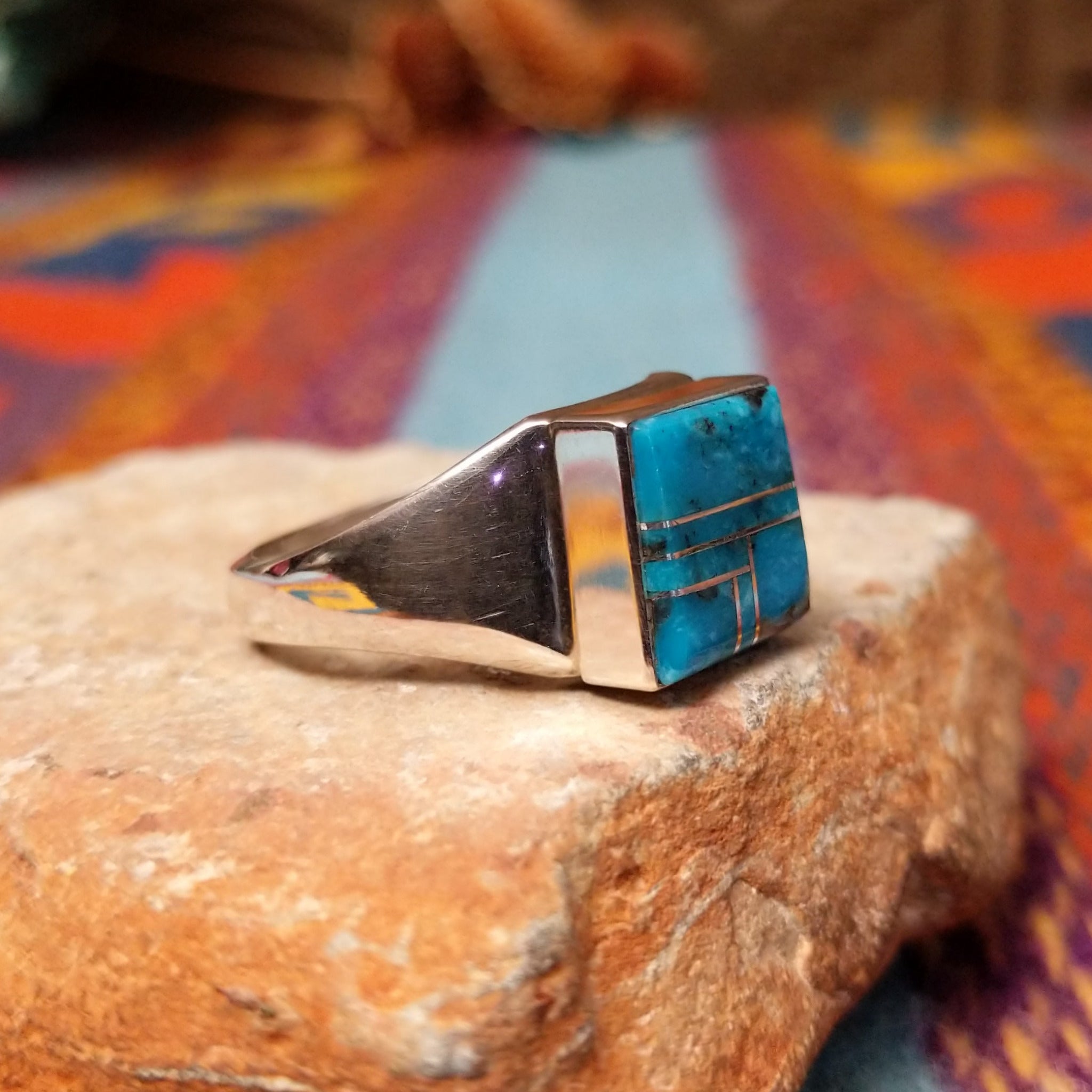 Turquoise Square Inlay Ring by Wilbert Grey featuring geometric turquoise inlay with natural matrix, separated by Sterling Silver channels and set on a polished tapered silver band; side view.