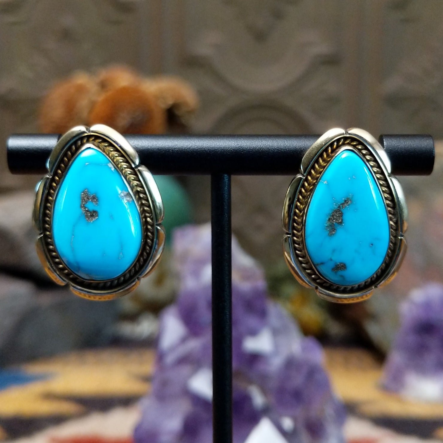 14kt gold Tom Lewis earrings with teardrop turquoise and rope bezel detailing.