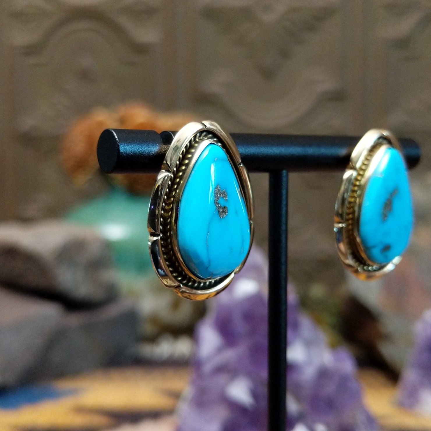 14kt gold Tom Lewis earrings with teardrop turquoise and rope bezel detailing.