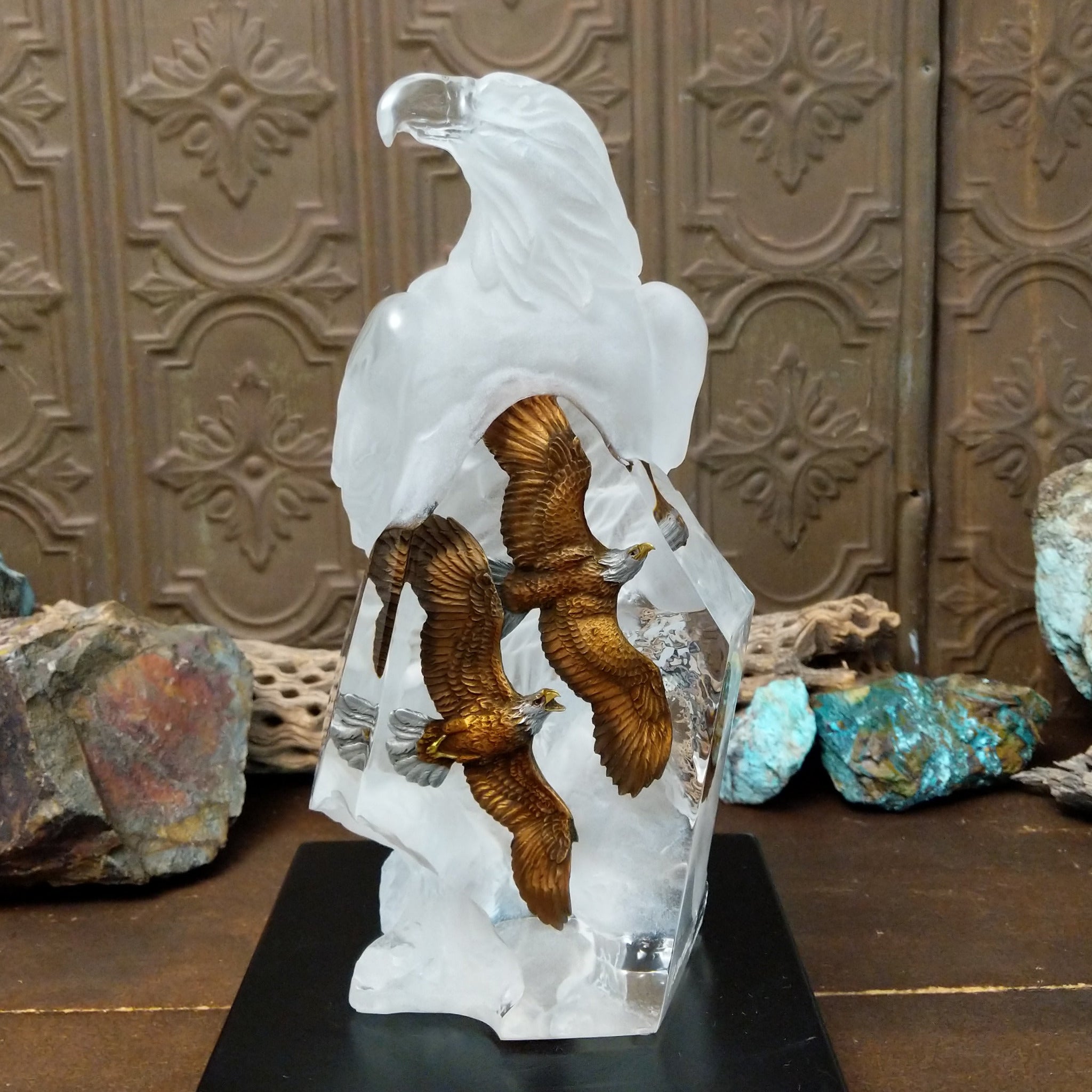 A frosted Lucite sculpture of a bald eagle with two hand-painted bald eagles soaring through the clear crystal interior.