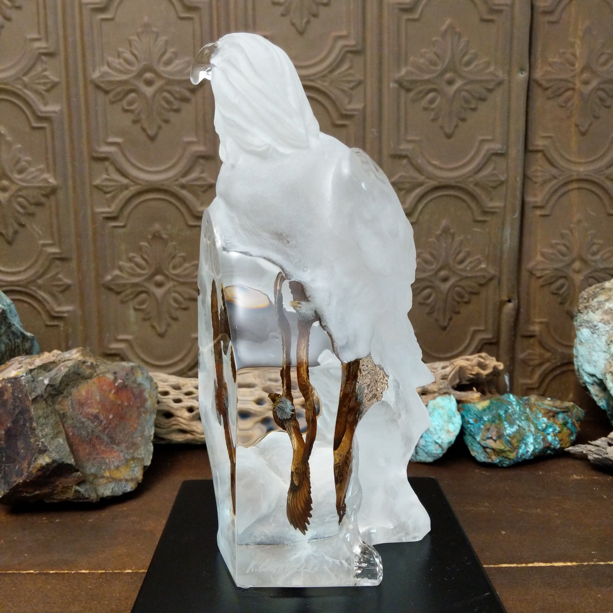 A frosted Lucite sculpture of a bald eagle with two hand-painted bald eagles soaring through the clear crystal interior.