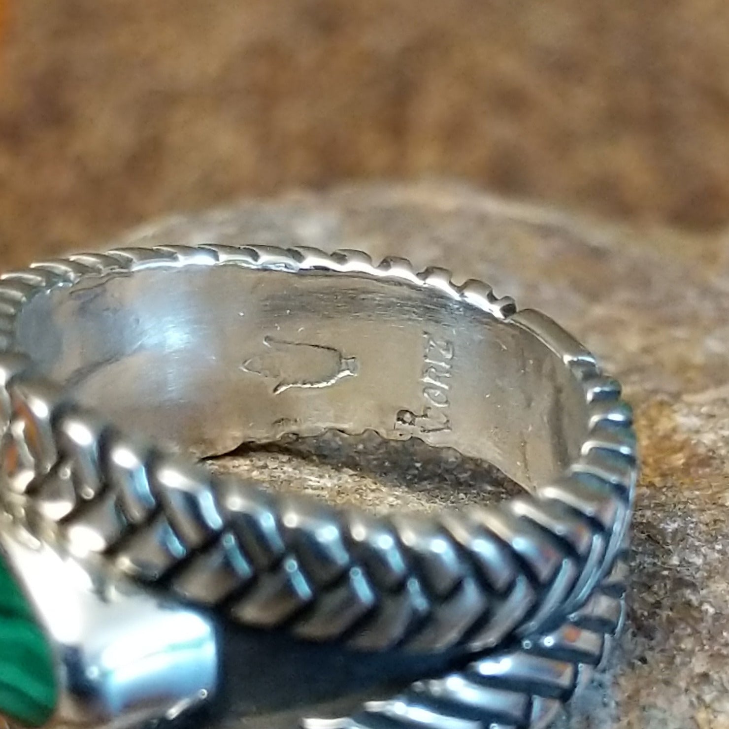 Close-up of the artisan's stamped signature.