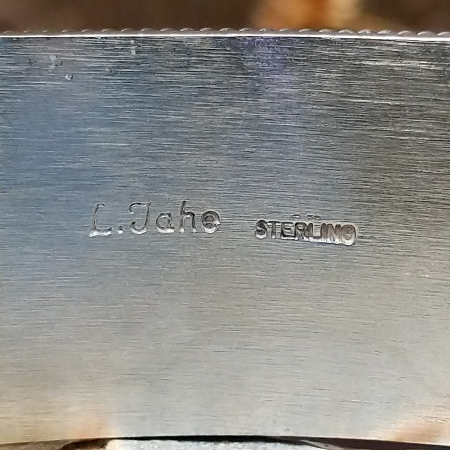 Close up of the artist's stamped signature.
