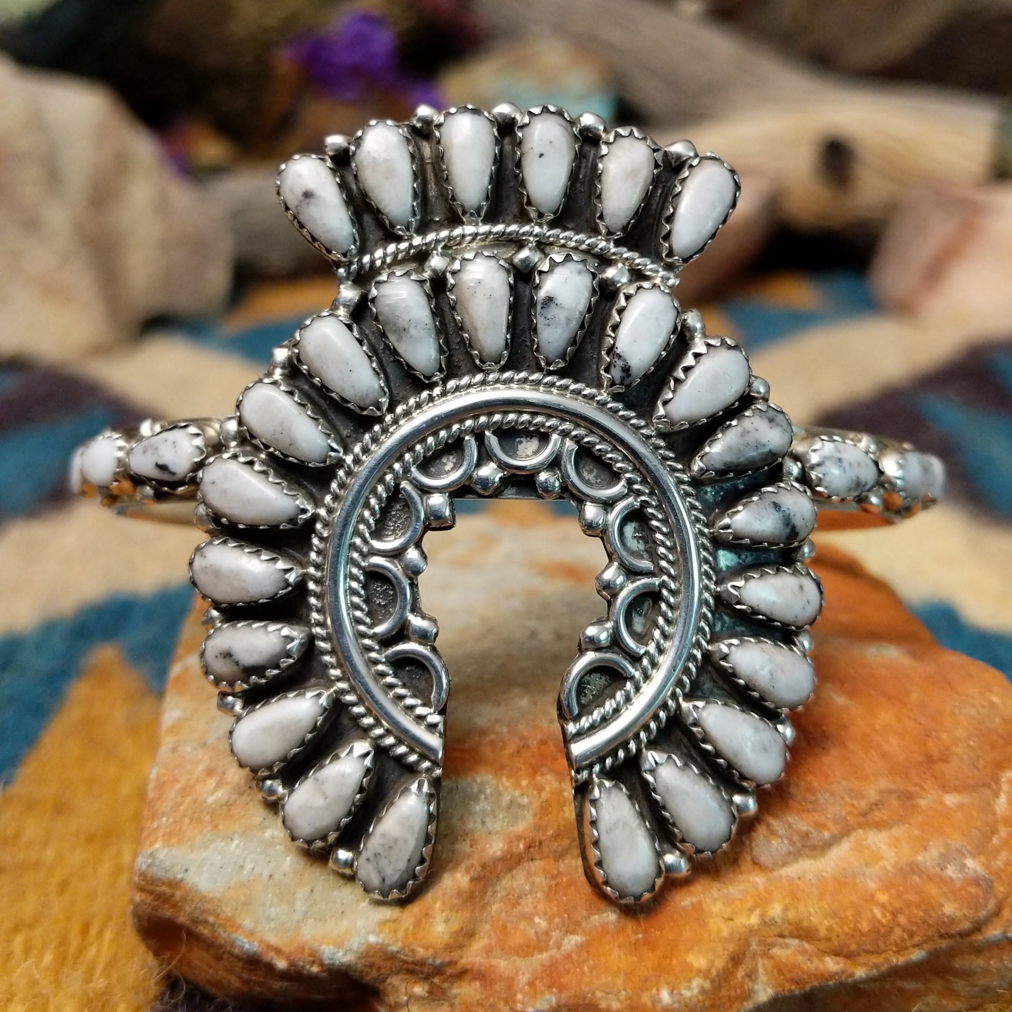 Handcrafted sterling silver Naja cuff by Zeta Begay featuring White Buffalo stones in a fan pattern with twisted rope detailing, silver bead accents, and traditional Navajo craftsmanship.