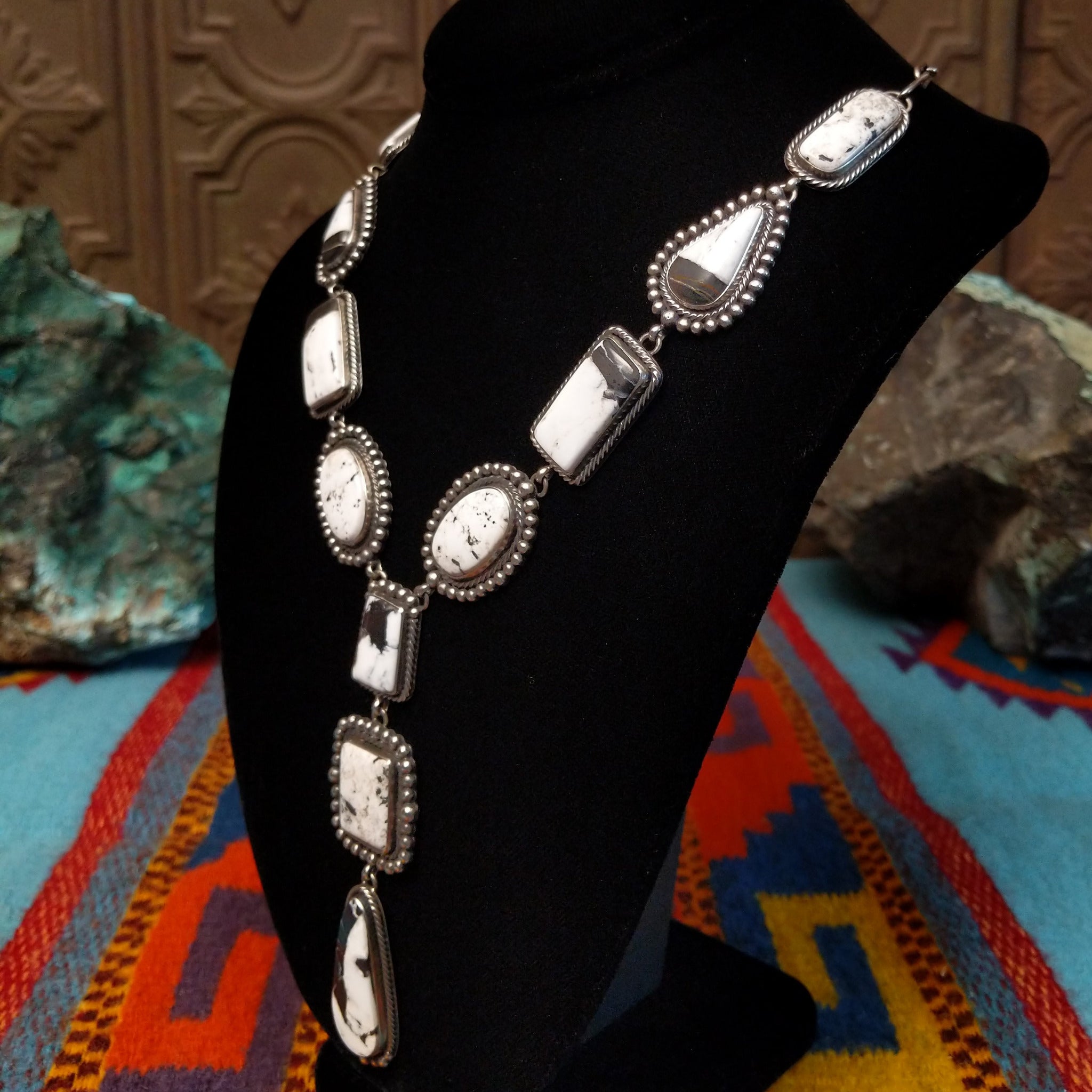 Southwestern-style Sterling Silver necklace featuring White Buffalo stones with natural black and gray matrix; side view.