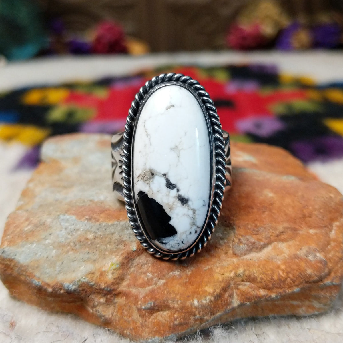 White Buffalo Oval Ring by Angel Martin & Bernyse Chavez with a large black-and-white stone set in a twisted rope-style sterling silver frame.
