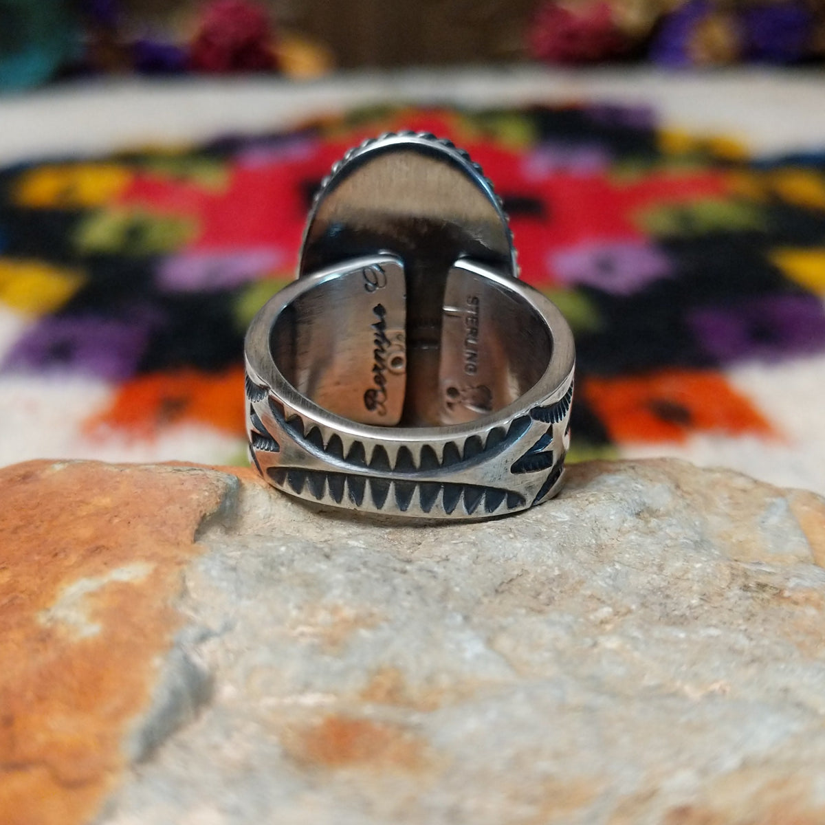 White Buffalo Oval Ring by Angel Martin & Bernyse Chavez with a large black-and-white stone set in a twisted rope-style sterling silver frame; underside view.