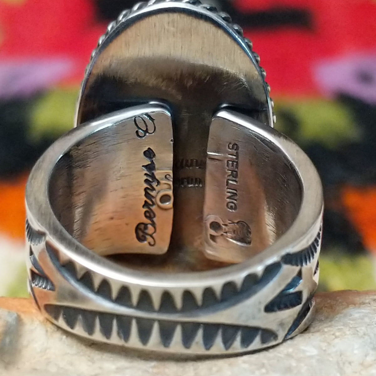 White Buffalo Oval Ring by Angel Martin & Bernyse Chavez with a large black-and-white stone set in a twisted rope-style sterling silver frame; artisan and Sterling Silver stamp.