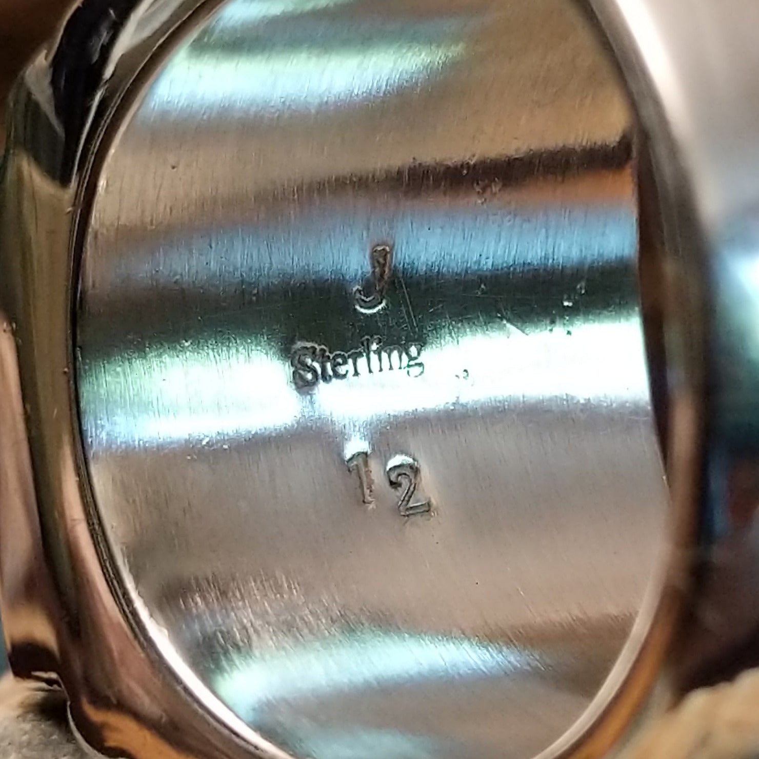 Close-up of the artisan's stamped signature.