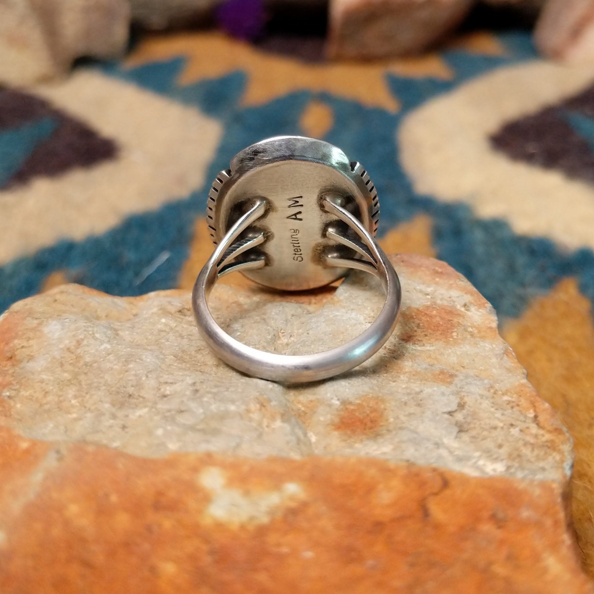 White Buffalo sterling silver ring by Alfred Martinez with an oval white stone and natural black veining; underside view.