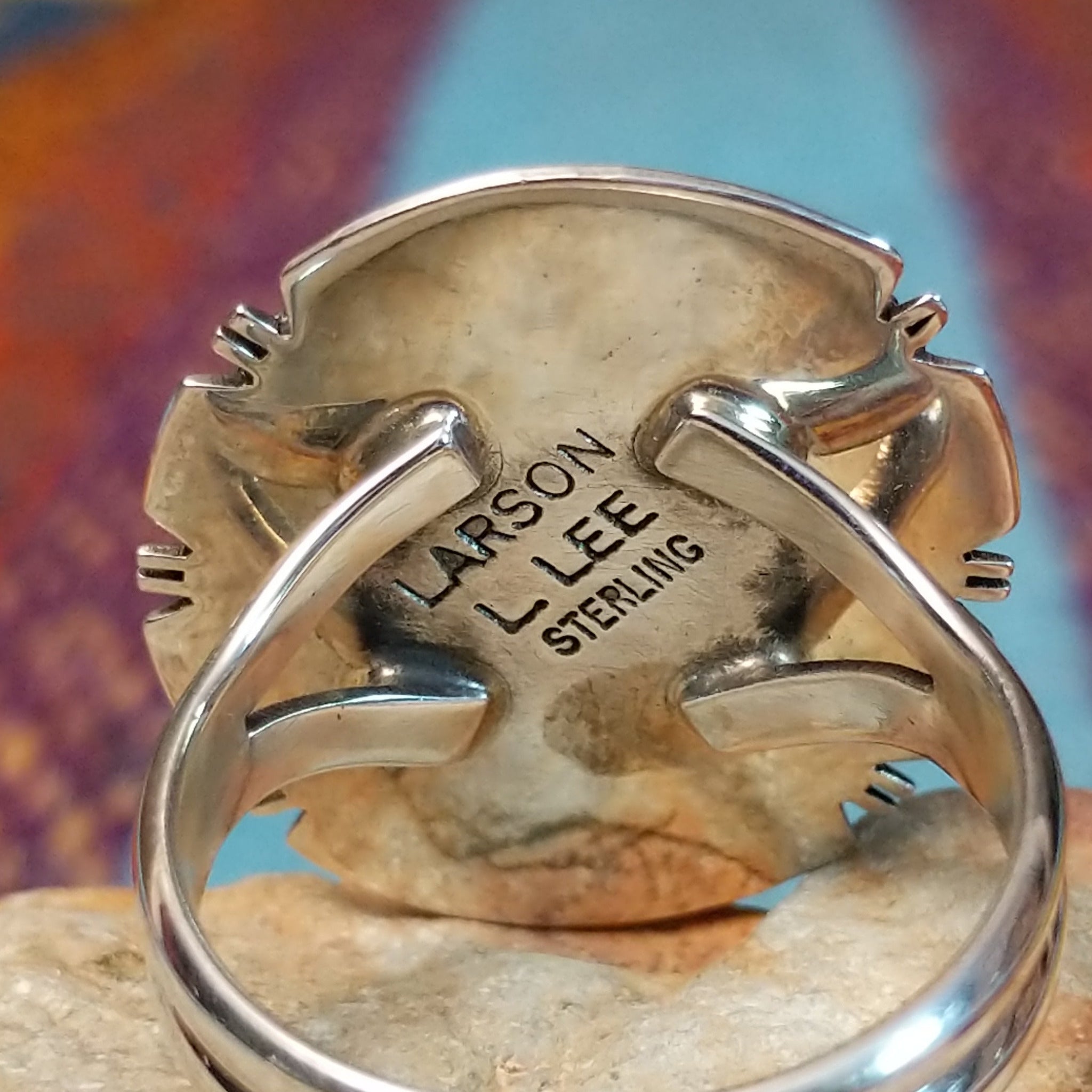 White Buffalo Round Ring by Larson Lee featuring a large White Buffalo stone with black matrix set in Sterling Silver with twisted rope and geometric silver detailing; artisan and Sterling Silver stamp.