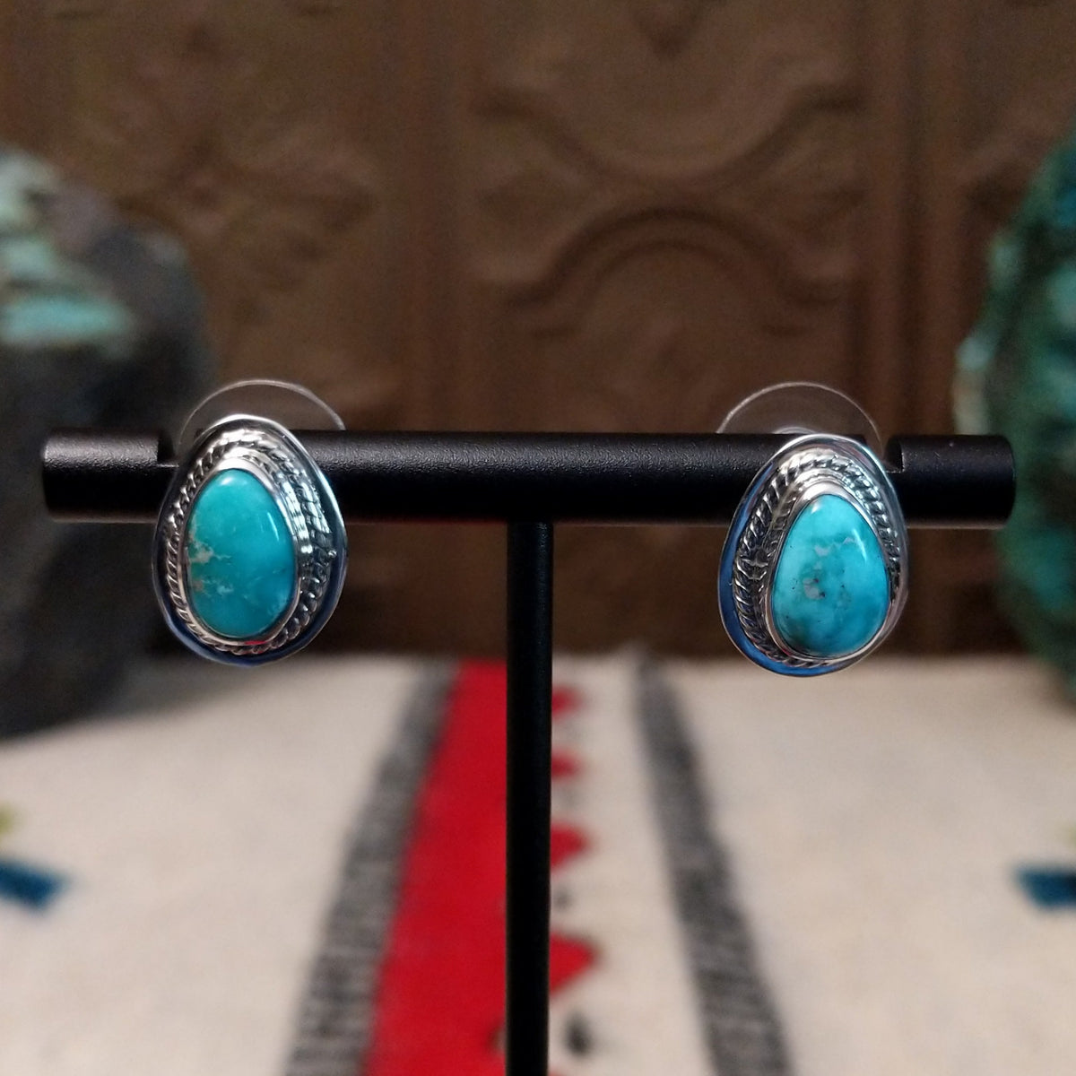 Whitewater turquoise stud earrings by L.P. featuring teardrop-shaped turquoise stones with natural matrix set in polished sterling silver with twisted rope detailing.