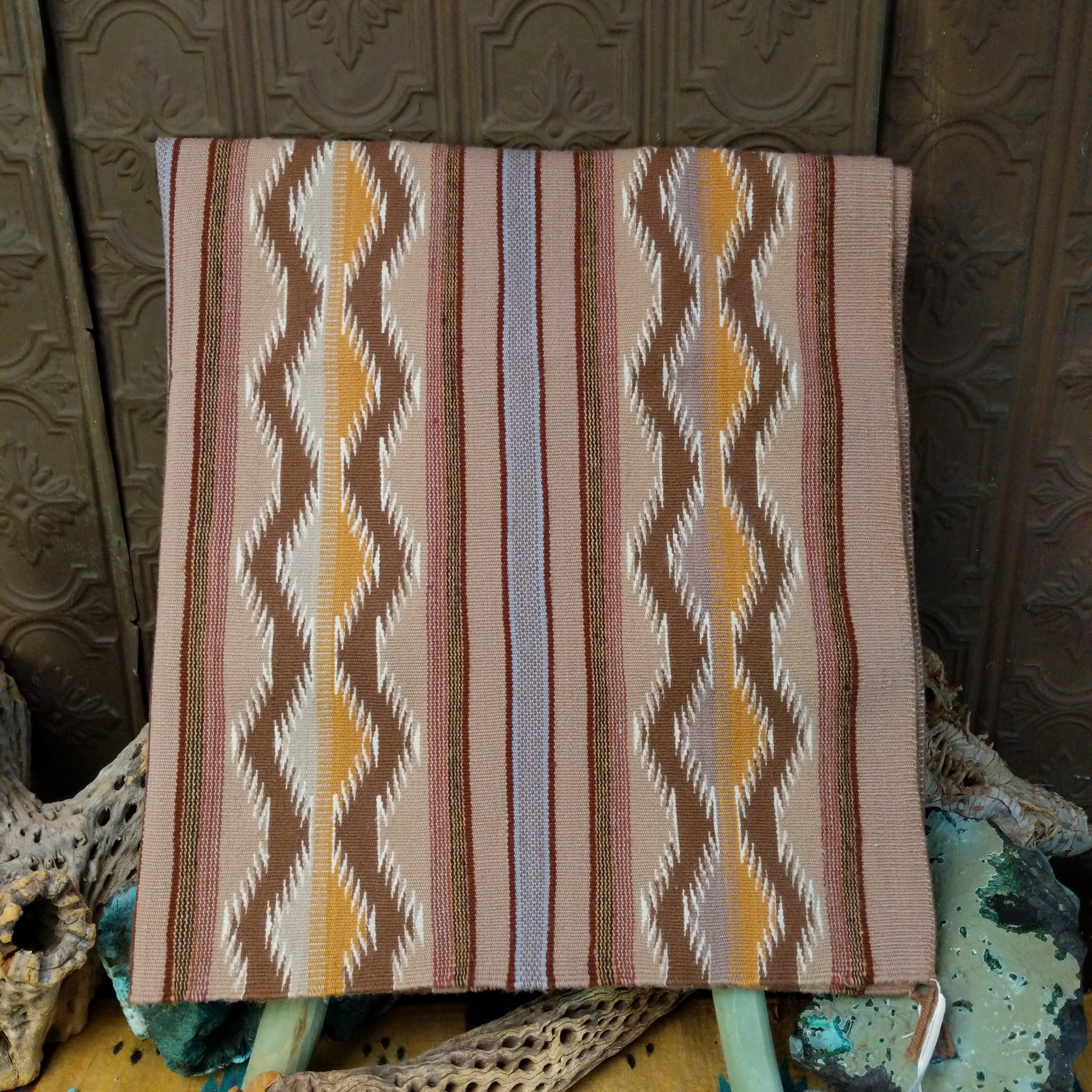 Wide Ruins Navajo rug by Irma Francis with vertical striped and diamond patterns in tan, brown, cream, muted blue, and golden yellow.