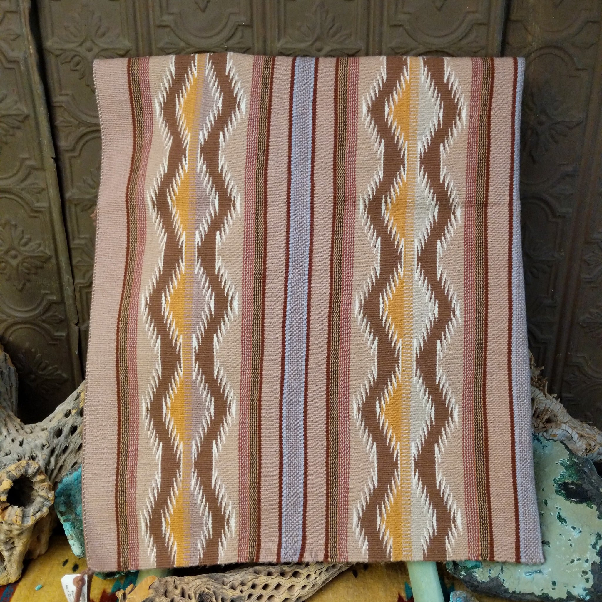 Wide Ruins Navajo rug by Irma Francis with vertical striped and diamond patterns in tan, brown, cream, muted blue, and golden yellow.