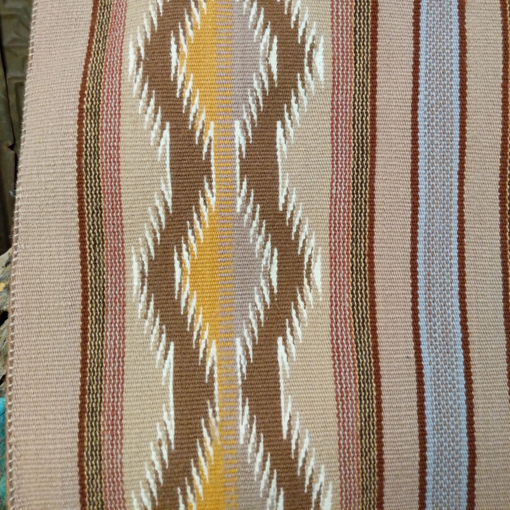 Wide Ruins Navajo rug by Irma Francis with vertical striped and diamond patterns in tan, brown, cream, muted blue, and golden yellow.