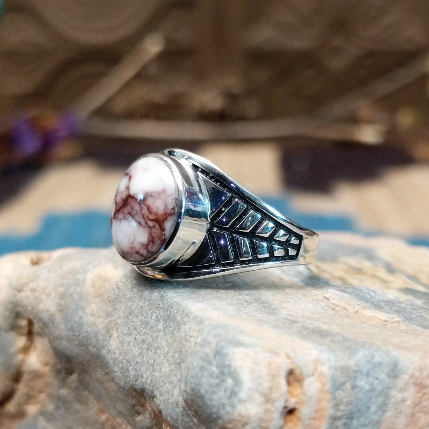 Sterling silver ring features wild horse stones set in round bezel and stamping on the band.
