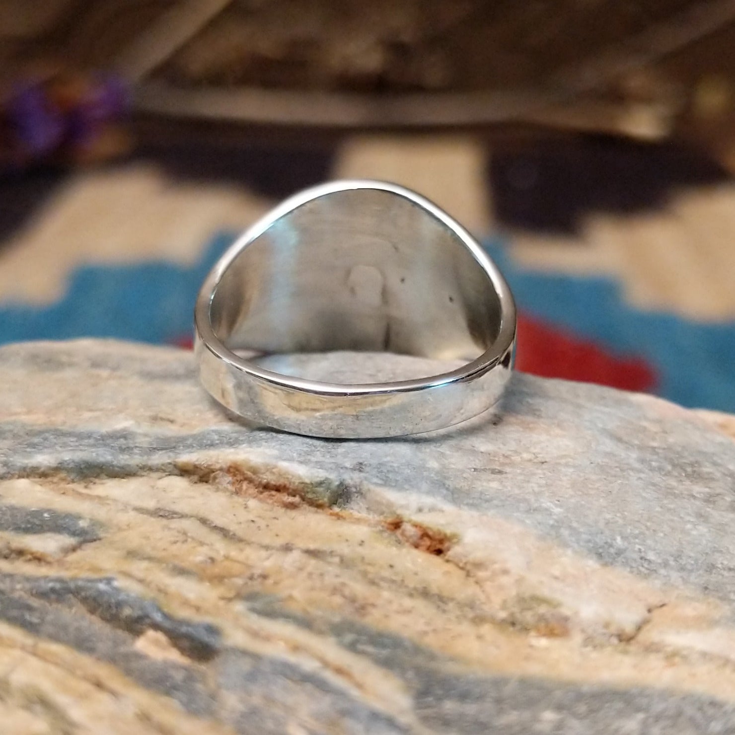Sterling silver ring features wild horse stones set in round bezel and stamping on the band.