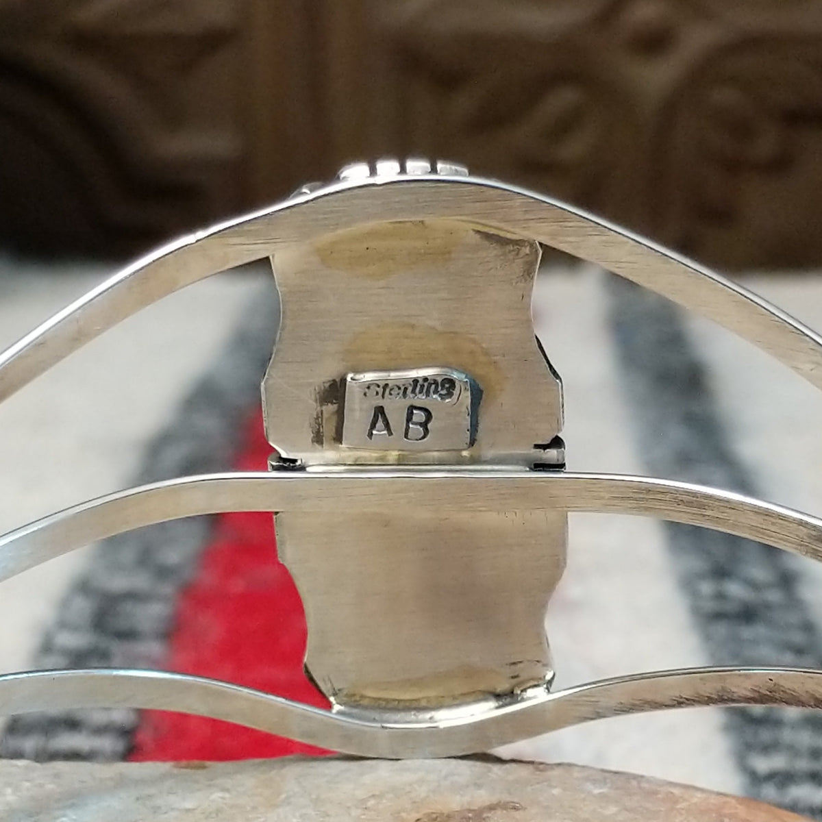 Silver cuff by Amory Begay featuring a long rectangular Wild Horse stone with creamy white and brown matrix, framed by polished silver and curved split bands; artisan and Sterling Silver stamp.