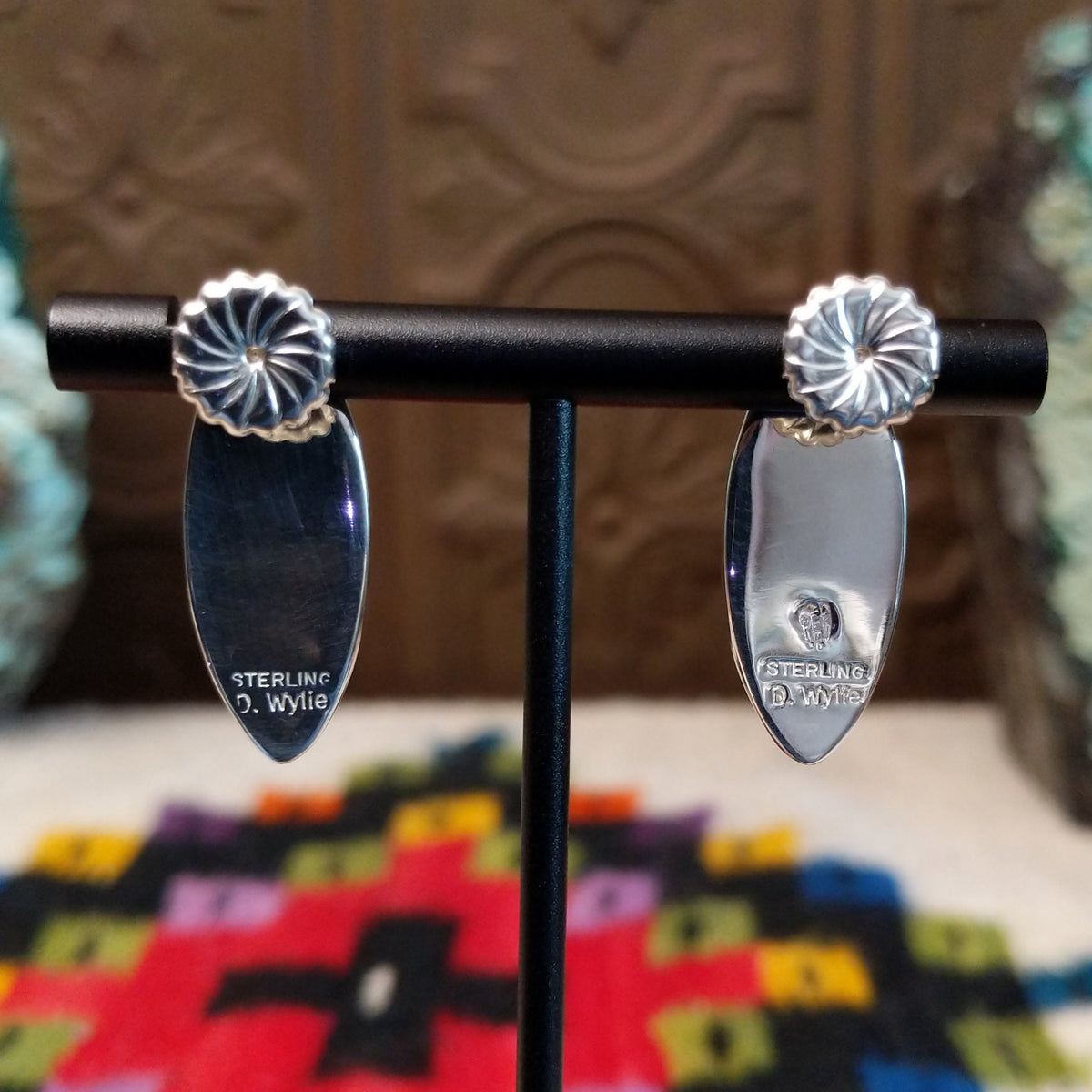 Wild Horse Earrings by Diane Wylie featuring elongated navette-shaped stones with white and reddish-brown matrix patterns set in smooth silver bezels; artisan and Sterling Silver stamp.