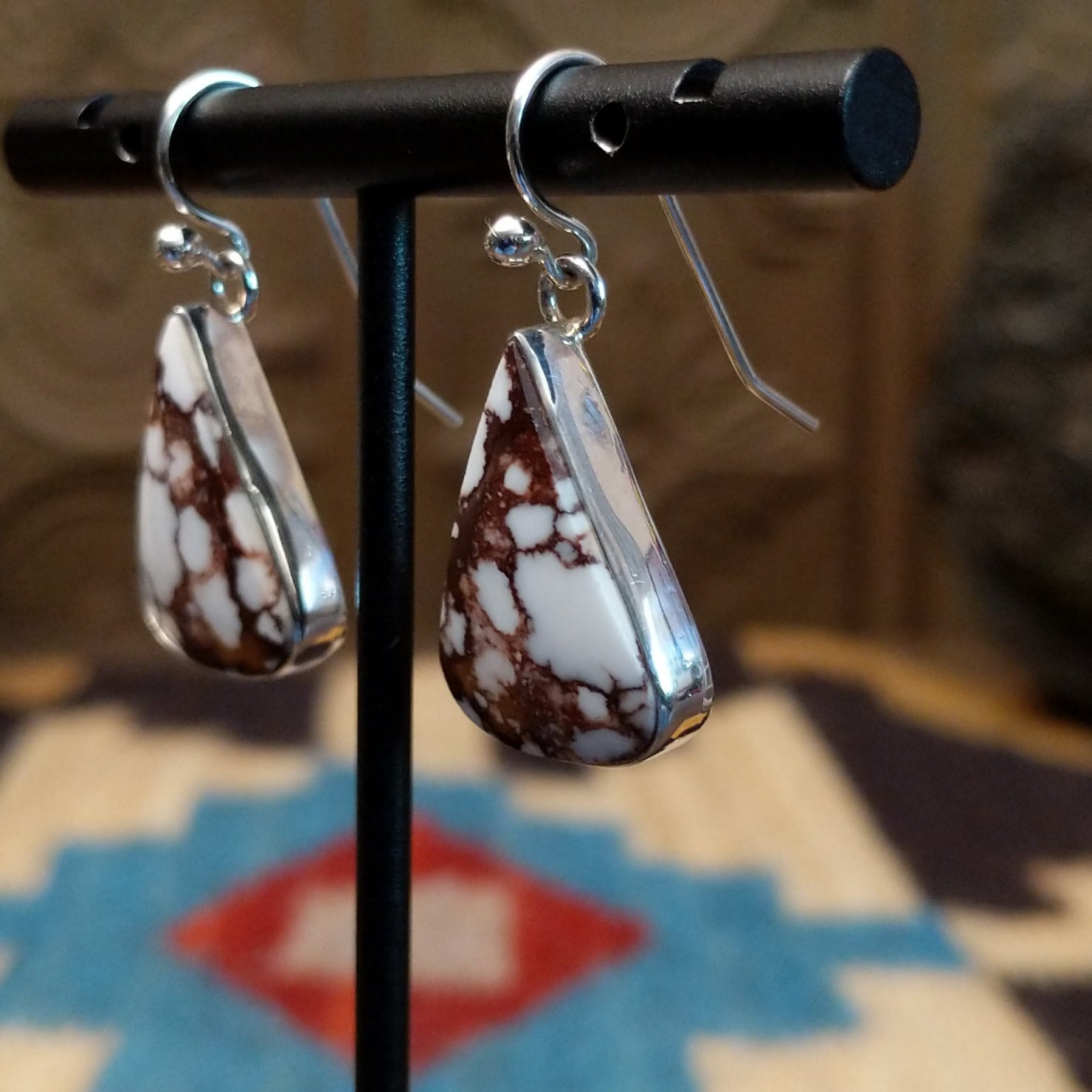 Sterling silver earrings featuring wild horse stones set in a triangular bezel.