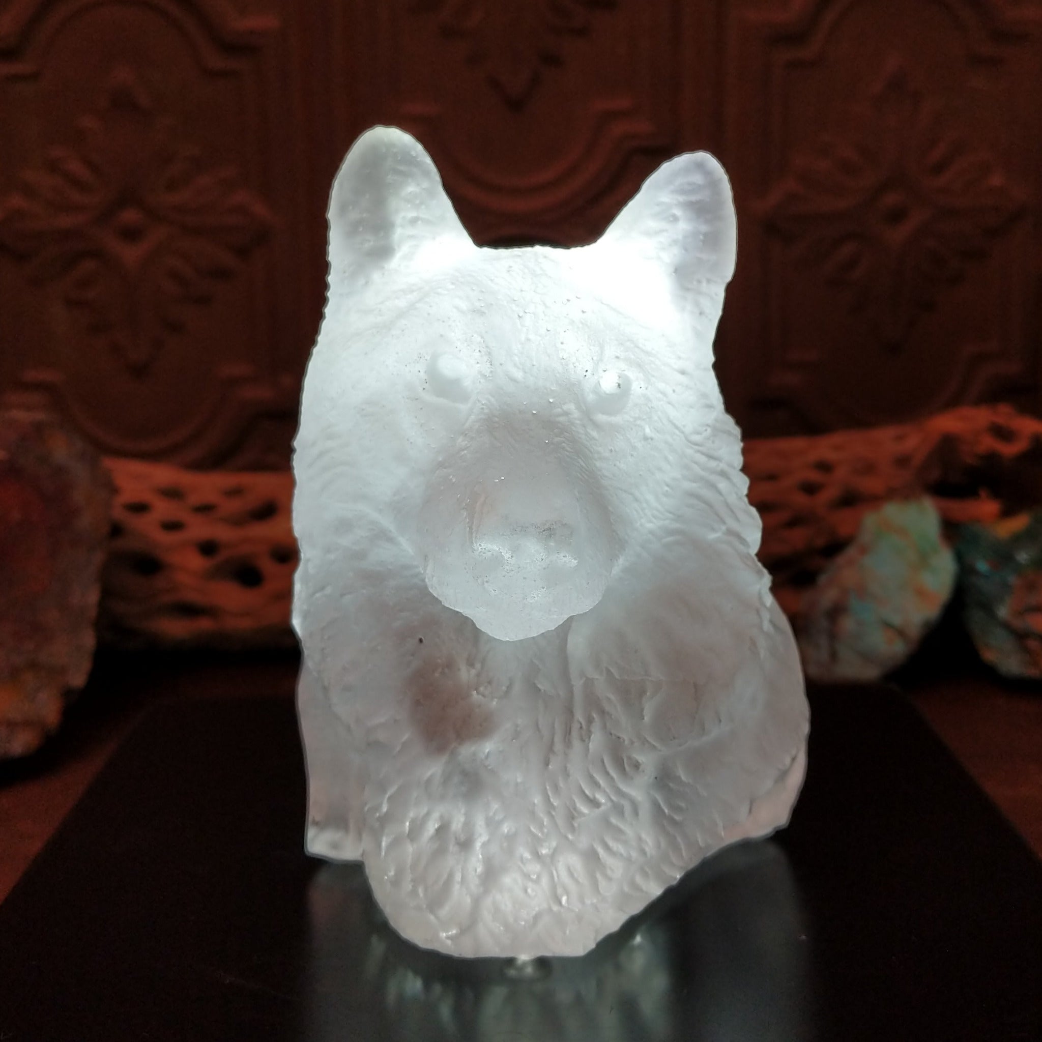 A frosted Lucite sculpture shaped like a wolf's head; lower light display.