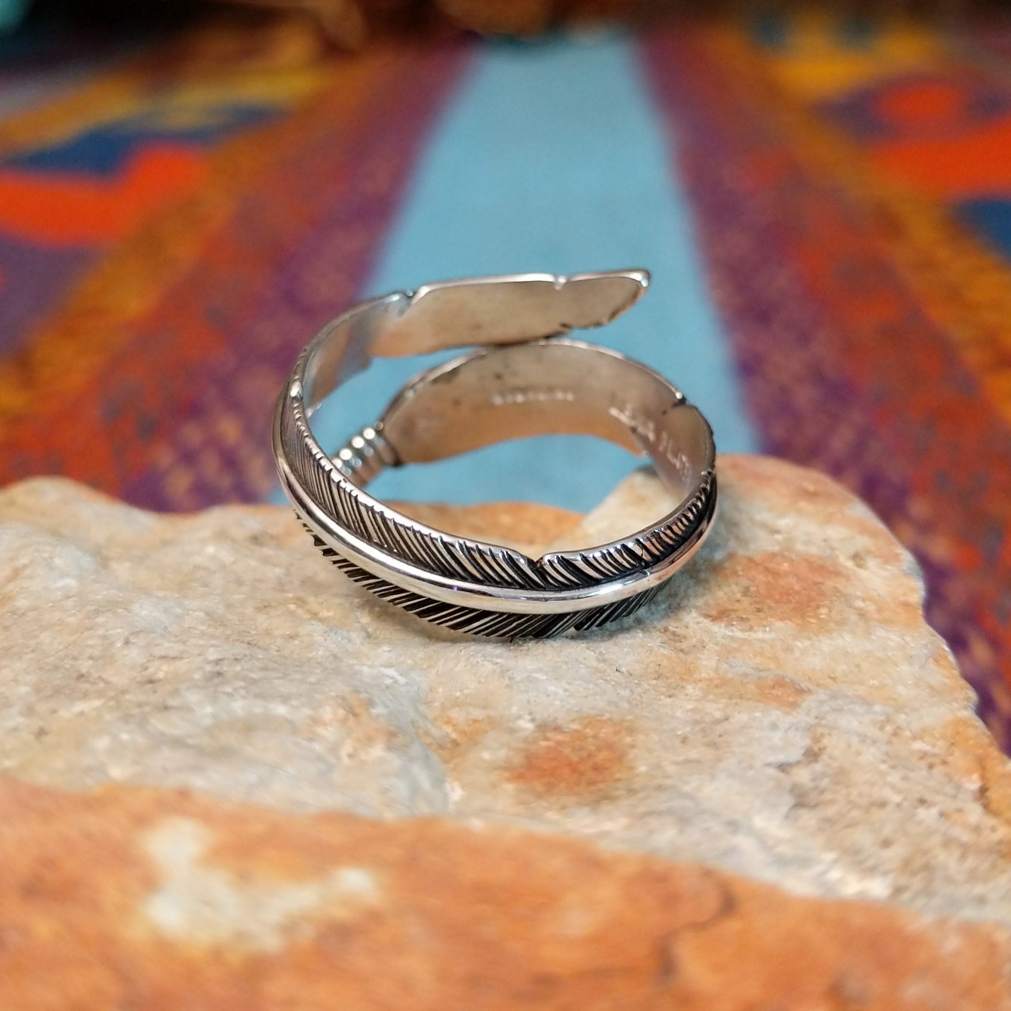 Wrapped Silver Feather Ring by Lena Platero with overlapping detailed feathers.
