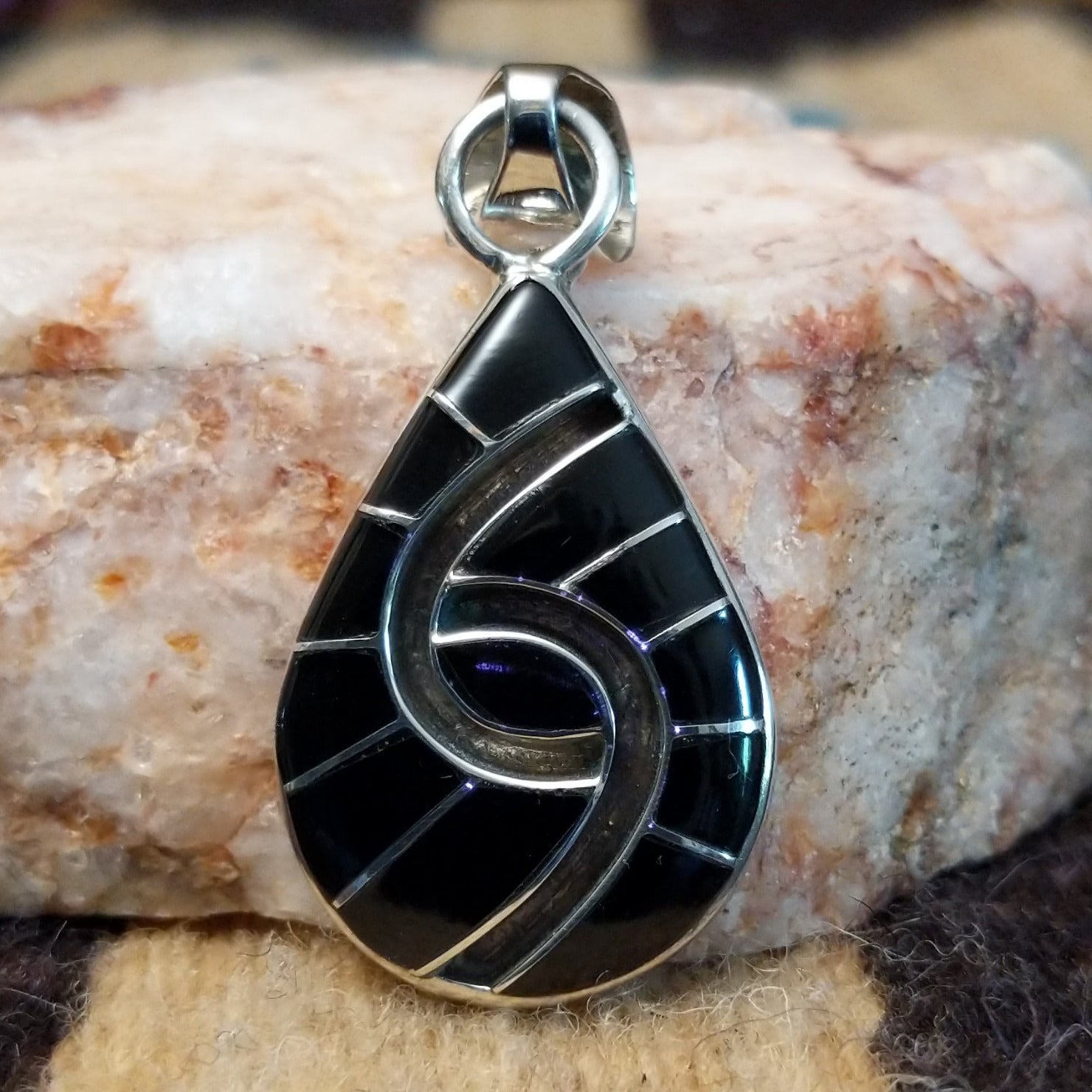 Sterling silver pendant with black onyx inlaid in the spiral of the teardrop setting.