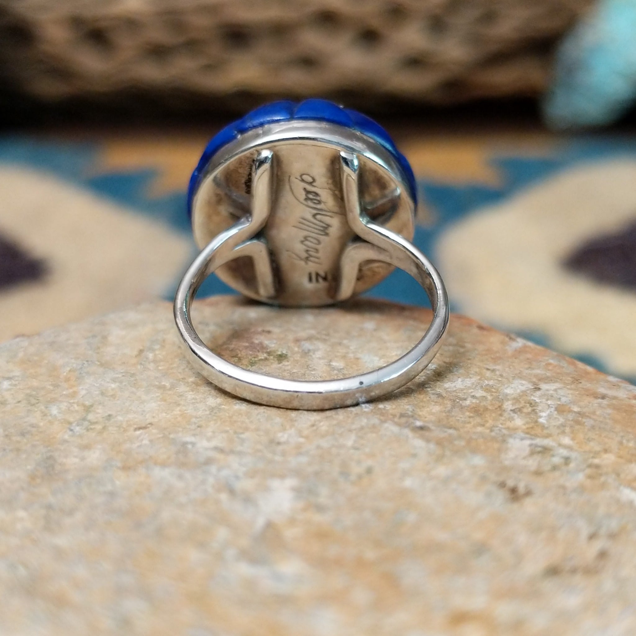 Handcrafted sterling silver Zuni dome ring by Lee & Mary Weebothee, featuring a colorful Sunface-inspired multistone inlay surrounded by lapis; underside view.