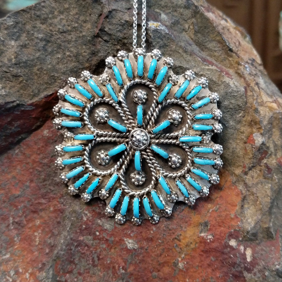 Zuni flowery needlepoint turquoise pendant and pin by Leekity featuring slender turquoise stones, twisted silver wire floral patterns, and decorative silver bead accents.