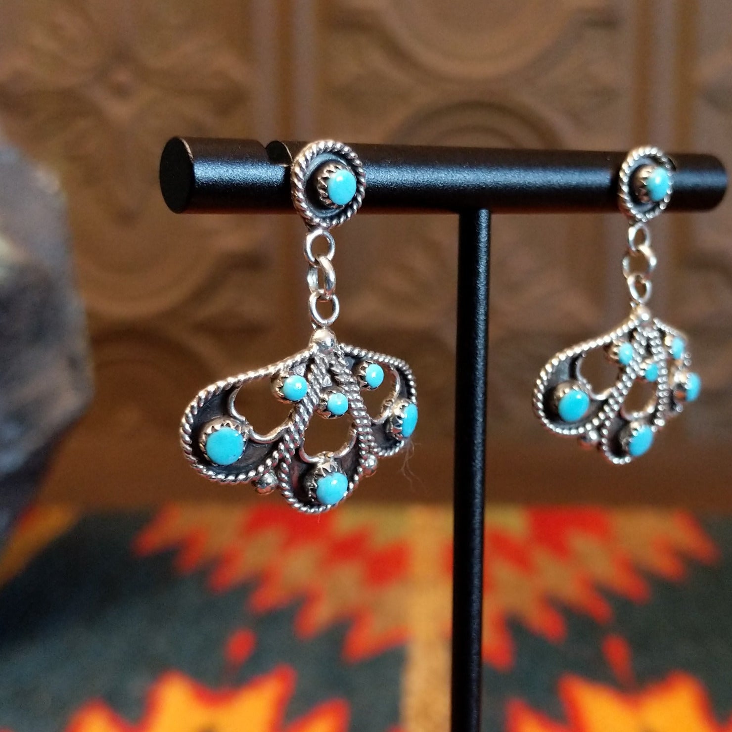 Sterling silver earrings with floral settings and turquoise set in the bezels.