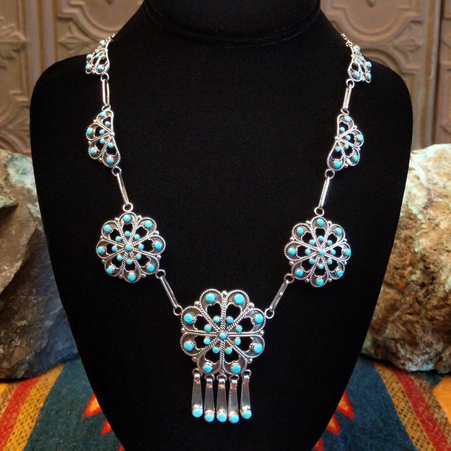 Sterling silver necklace with floral settings and turquoise set in the bezels.