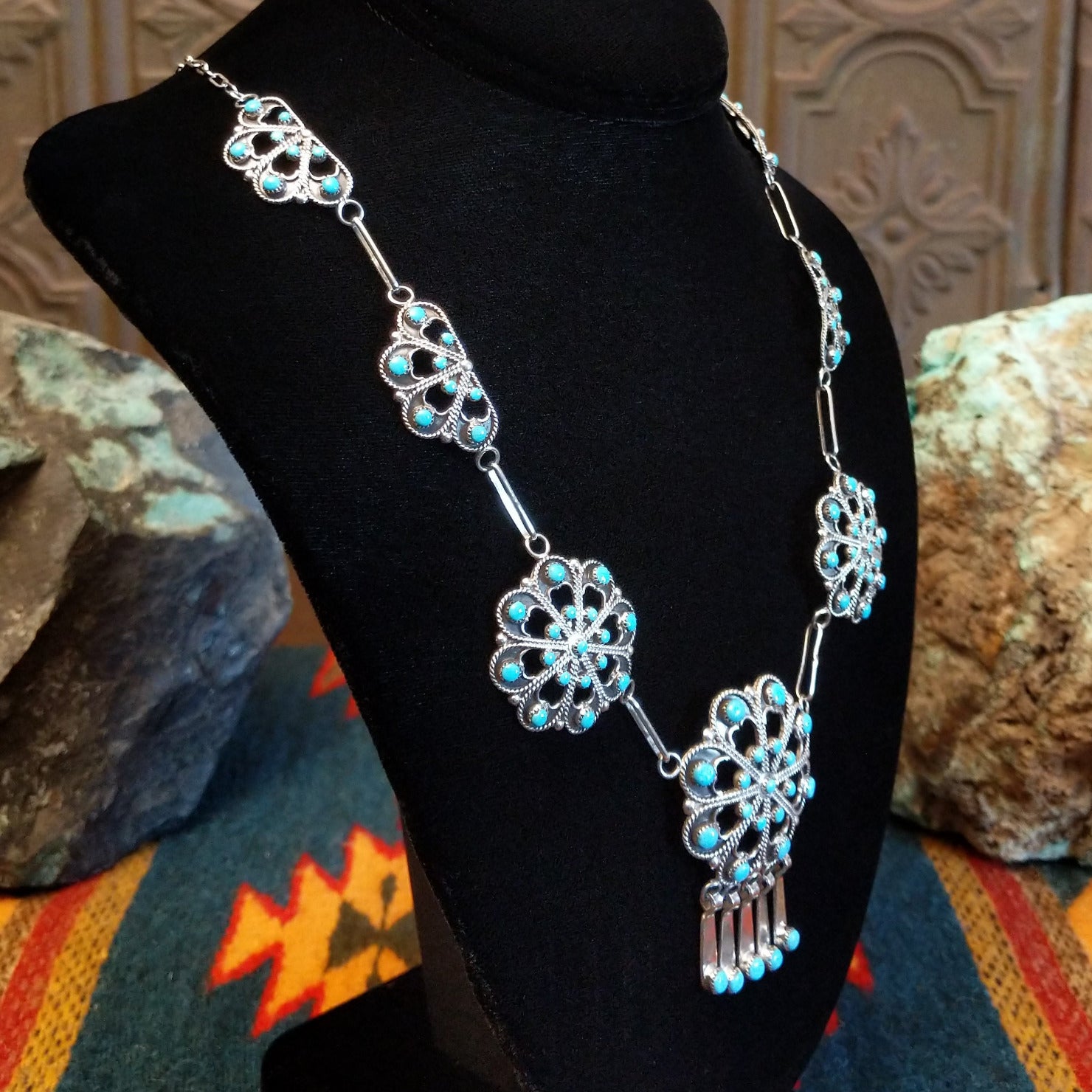 Sterling silver necklace with floral settings and turquoise set in the bezels.