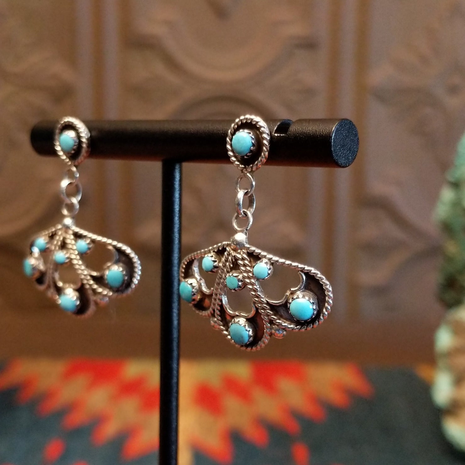 Sterling silver earrings with floral settings and turquoise set in the bezels.