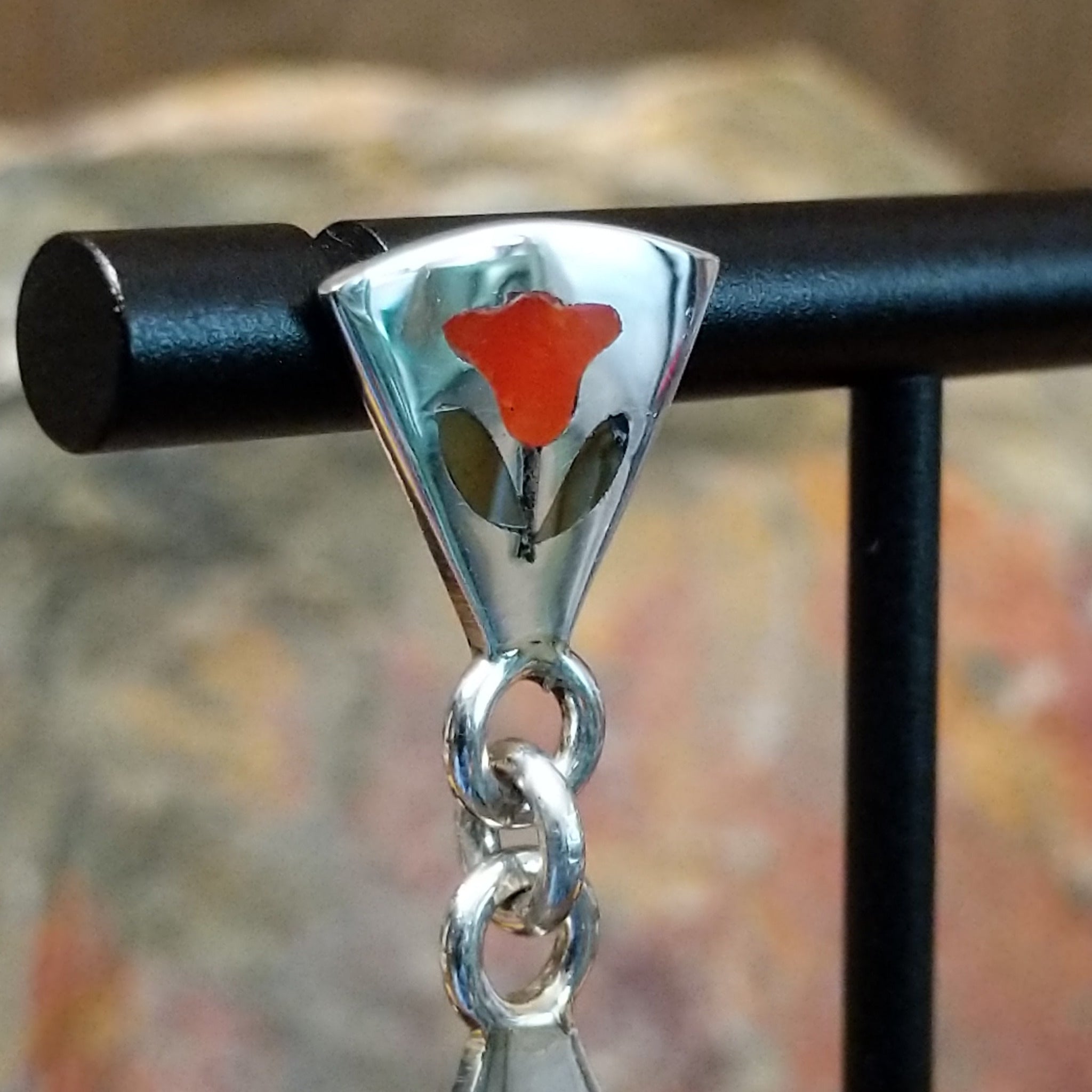 Handcrafted sterling silver Zuni hummingbird inlay earrings by Sanford Edaakie, featuring a two-piece dangle design with colorful flowers and hummingbirds; detail on post.