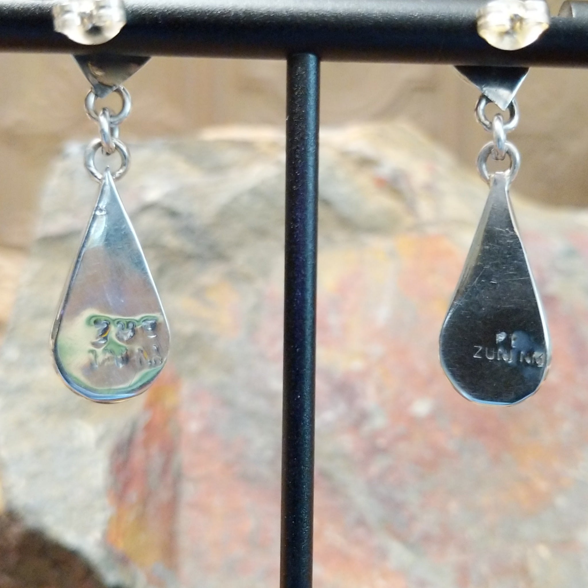 Handcrafted sterling silver Zuni inlay teardrop earrings by Florencia Lucio, featuring colorful multistone inlay in a classic teardrop design; artisan and tribe stamp.