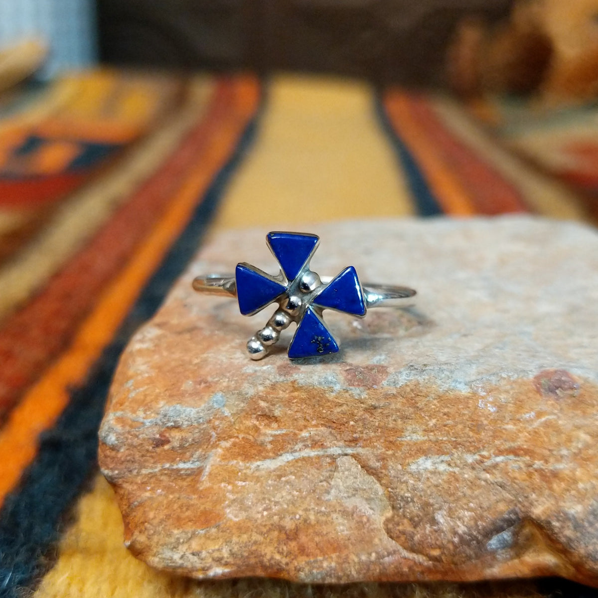 Zuni Lapis Dragonfly Ring featuring four triangular deep blue lapis lazuli inlay stones forming dragonfly wings, accented with sterling silver beads and a slender silver band.