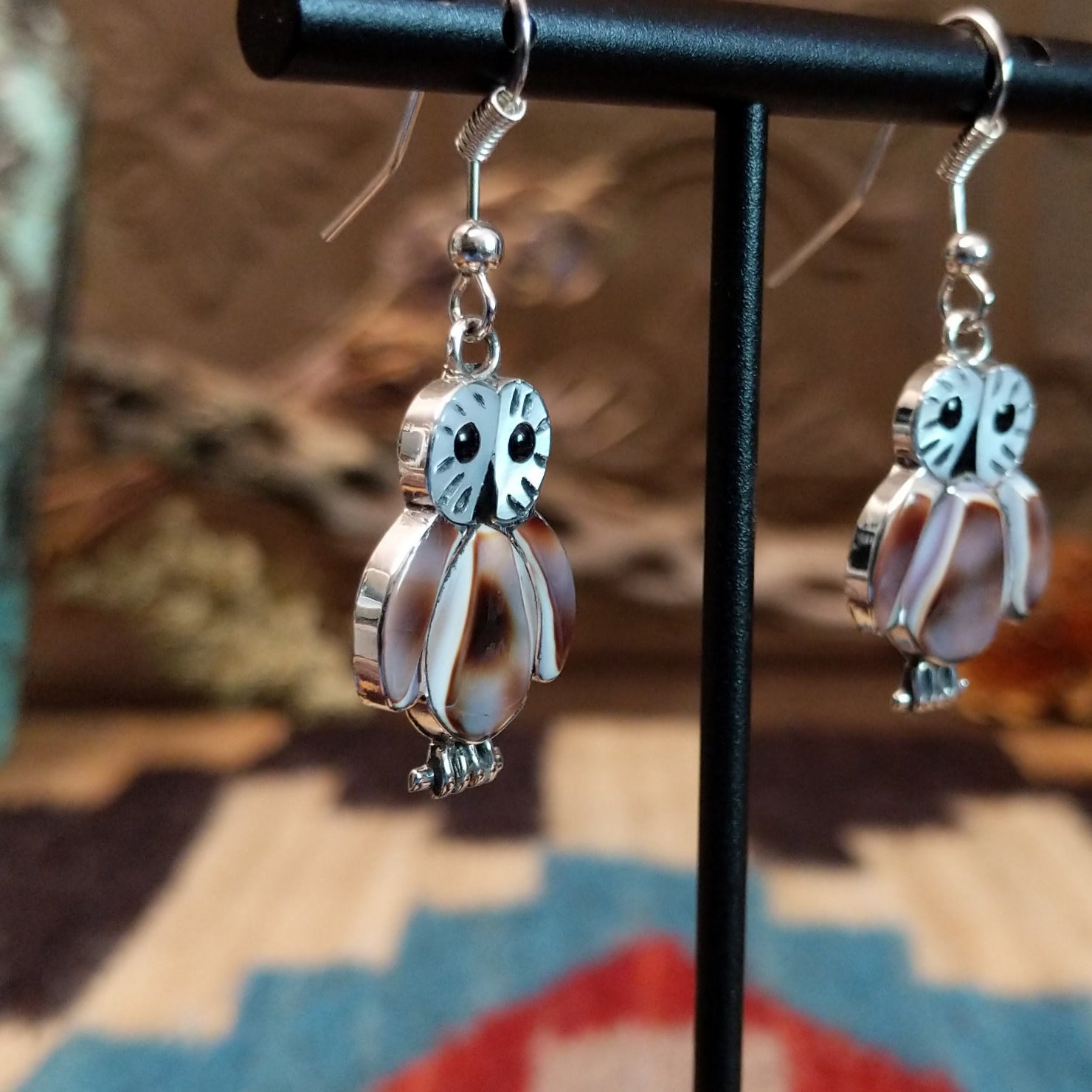 Sterling silver owl earrings with cowry shell, black onyx, and mother of pearl inlaid on the bezels.