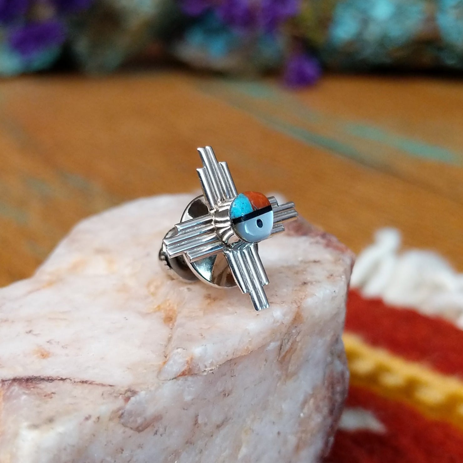 Sterling silver Zuni tie tack with sun symbol-inspired design and multistone center.