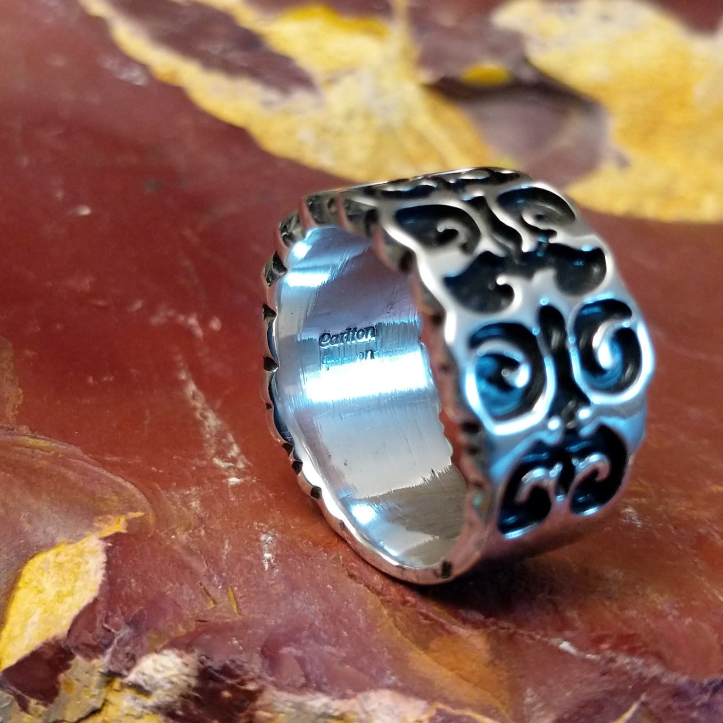 The interior of the ring features the artisan's stamped signature.